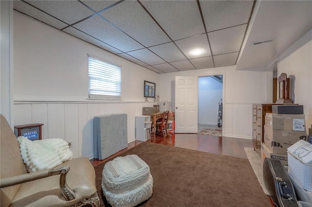 sitting room featuring hardwood / wood-style flooring and a paneled ceiling