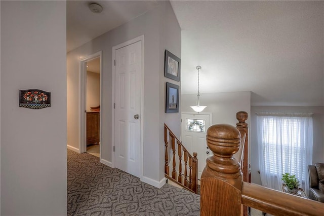 hallway with light colored carpet