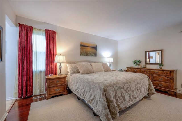 bedroom with dark wood-type flooring