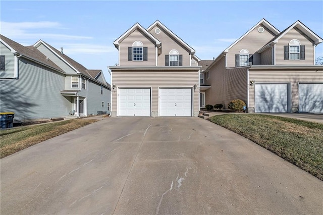 traditional-style house featuring concrete driveway and an attached garage