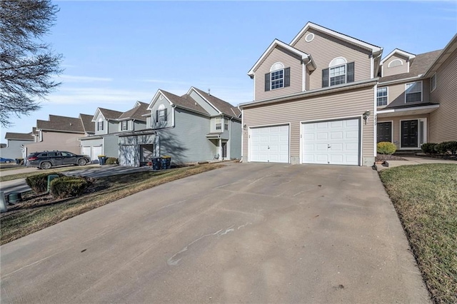 view of front facade featuring an attached garage, a residential view, and concrete driveway