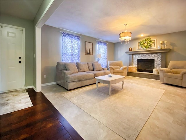 living room with a fireplace and a chandelier