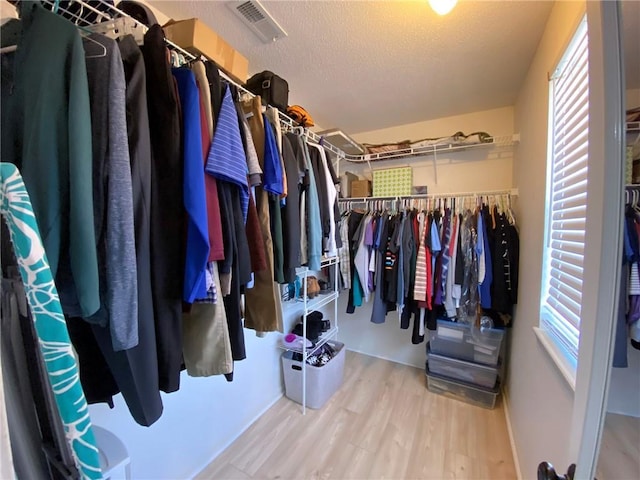 walk in closet with hardwood / wood-style floors