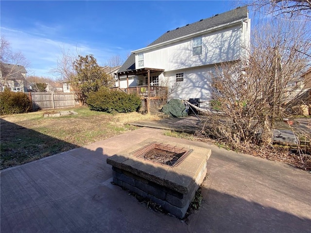 exterior space featuring an outdoor fire pit, a deck, and a patio area