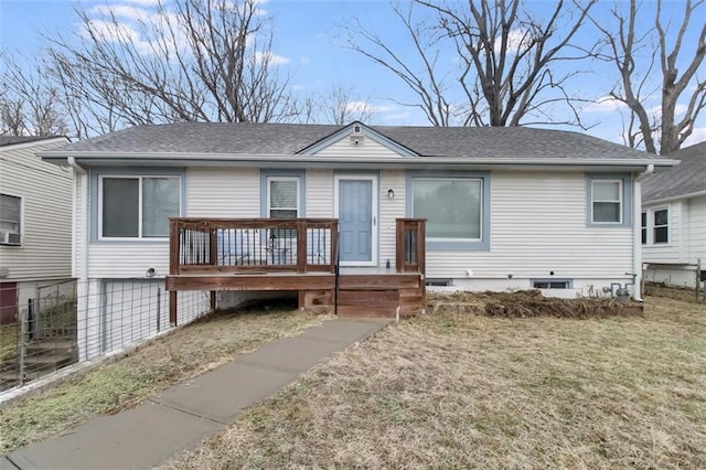 view of front facade with a deck and a front yard