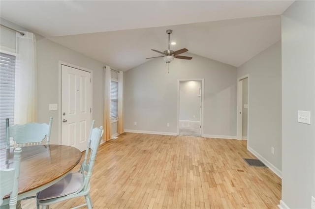 unfurnished dining area with vaulted ceiling, ceiling fan, and light hardwood / wood-style floors