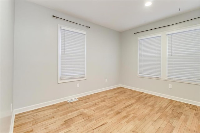 empty room with light hardwood / wood-style floors