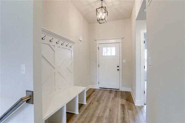 mudroom featuring light hardwood / wood-style floors and a chandelier