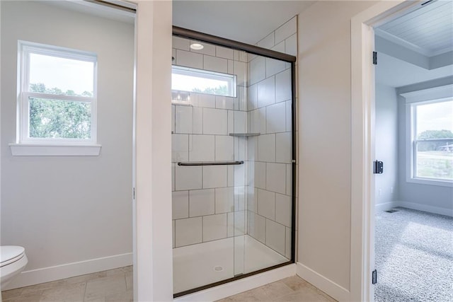 bathroom with an enclosed shower and toilet