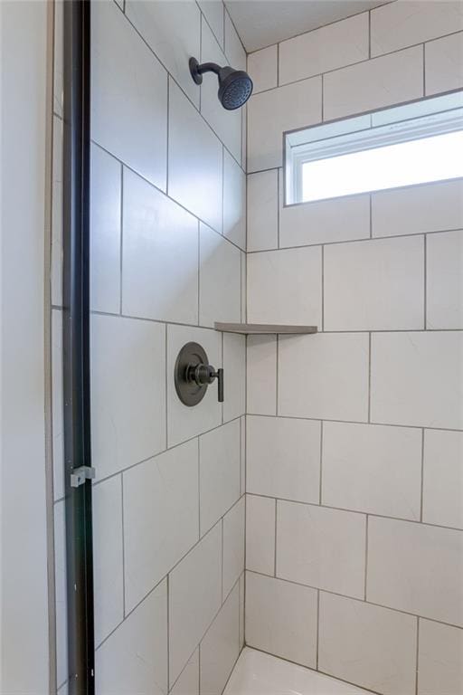 bathroom with tiled shower