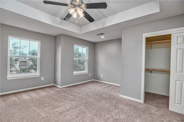 unfurnished bedroom featuring carpet, baseboards, visible vents, and a closet