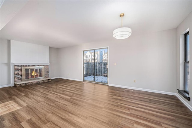 unfurnished living room with wood-type flooring and a fireplace