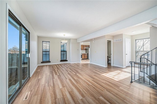 unfurnished living room with light hardwood / wood-style flooring