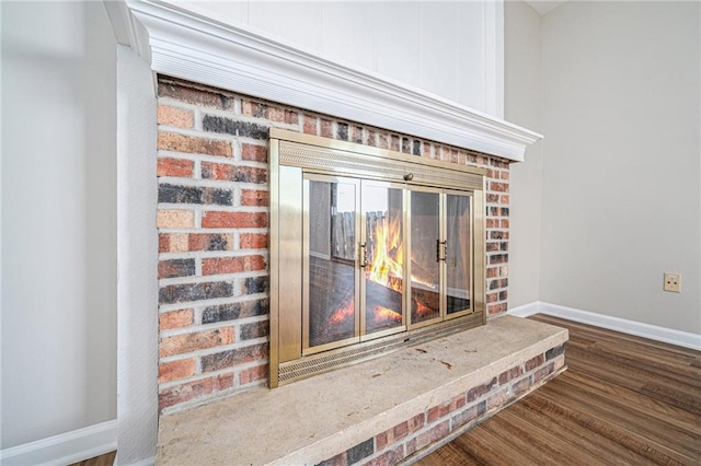 room details featuring hardwood / wood-style flooring and a brick fireplace