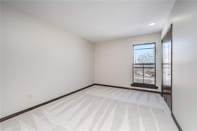 unfurnished room with light colored carpet