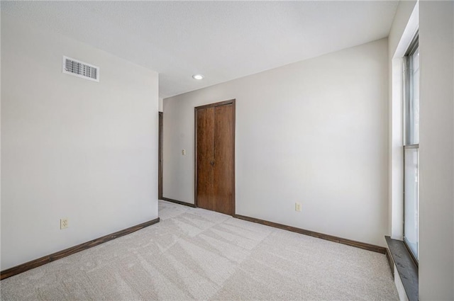 unfurnished room with light colored carpet