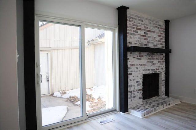 entryway featuring a fireplace and light hardwood / wood-style floors