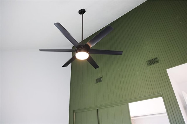 interior details with wooden walls and ceiling fan