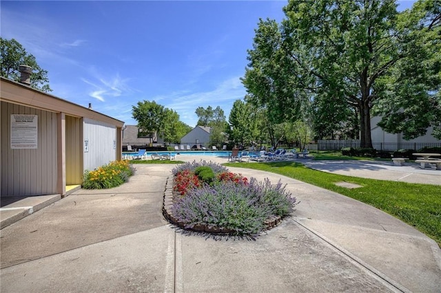 view of yard featuring a community pool and a patio area