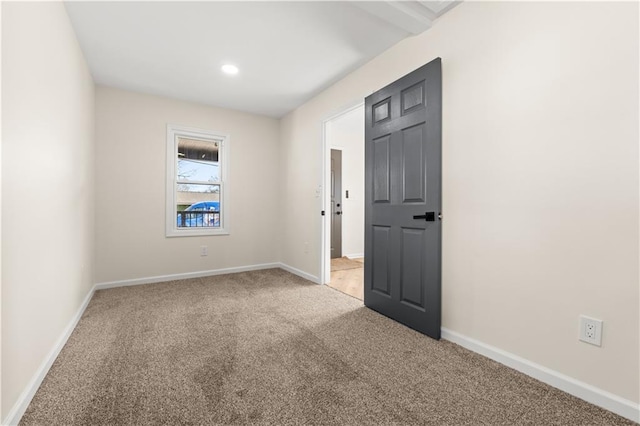 spare room with light colored carpet