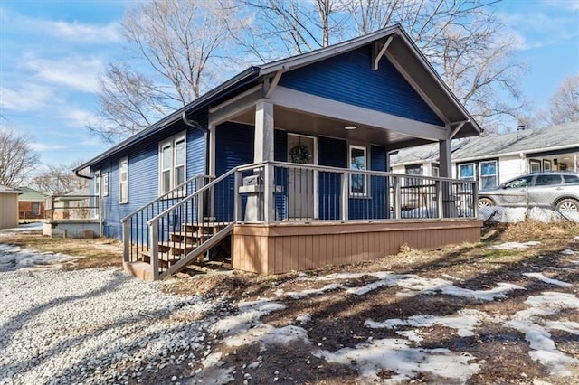 view of side of home with covered porch