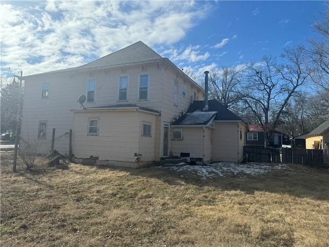 rear view of property with a yard