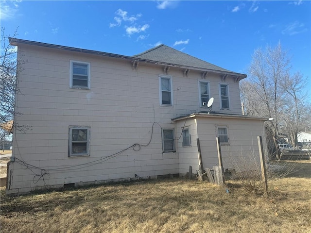 back of property featuring a yard