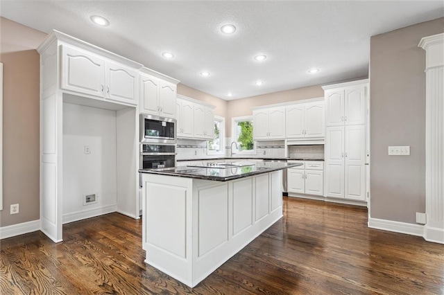 4749 SW Gull Point Dr, Lees Summit, MO 64082 - kitchen featuring stainless steel appliances, dark countertops, white cabinetry, dark wood-type flooring, and recessed lighting