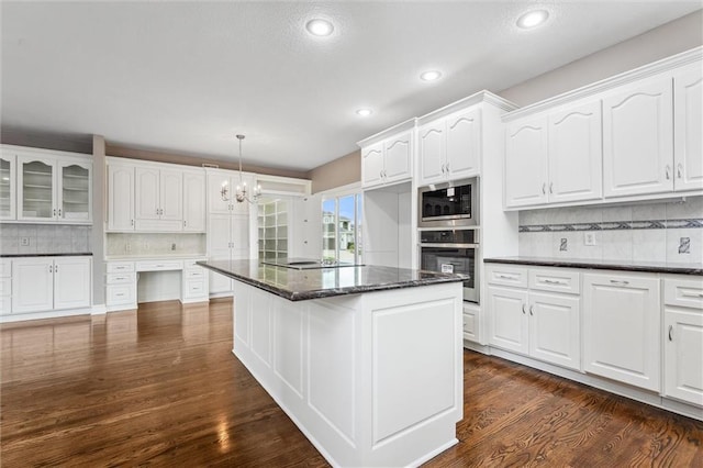 4749 SW Gull Point Dr, Lees Summit, MO 64082 - kitchen with appliances with stainless steel finishes, tasteful backsplash, white cabinetry, a chandelier, and recessed lighting