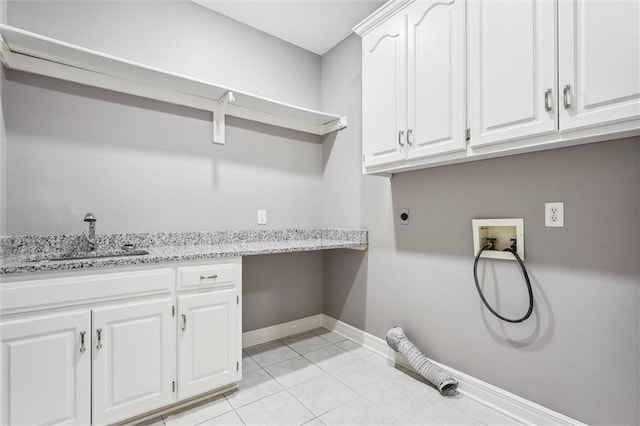 4749 SW Gull Point Dr, Lees Summit, MO 64082 - laundry room with hookup for a washing machine, cabinet space, hookup for an electric dryer, and light tile patterned floors