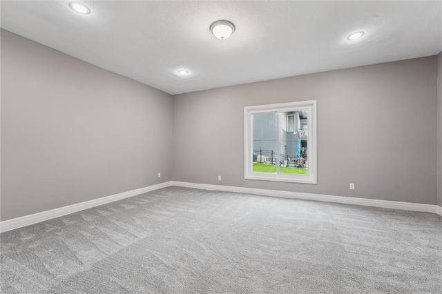 4749 SW Gull Point Dr, Lees Summit, MO 64082 - empty room featuring carpet flooring, recessed lighting, and a textured ceiling