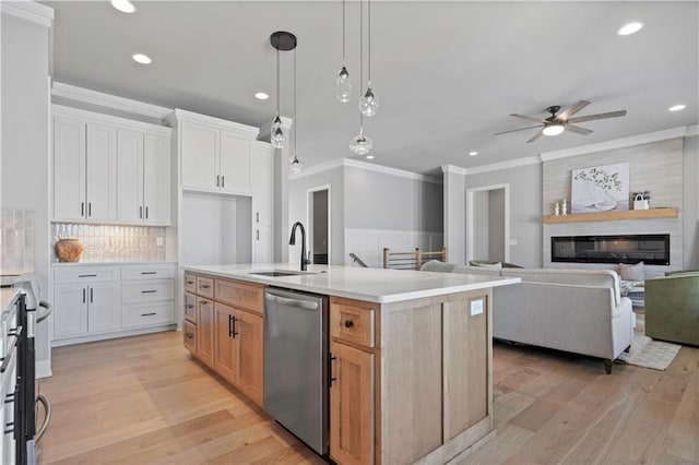 kitchen featuring sink, a center island with sink, white cabinets, and appliances with stainless steel finishes