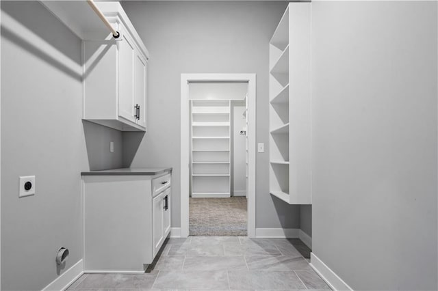 walk in closet with light colored carpet