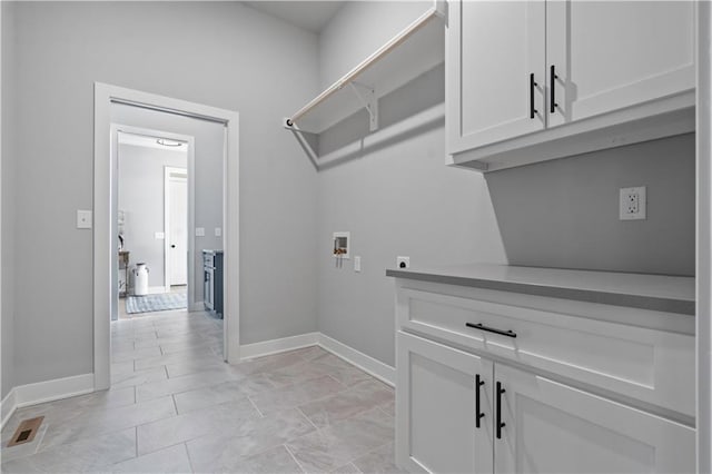 laundry area featuring cabinets, washer hookup, and electric dryer hookup