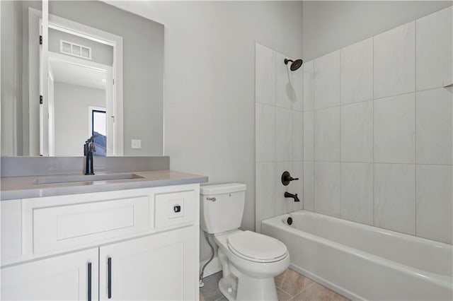 full bathroom featuring vanity, toilet, and tiled shower / bath