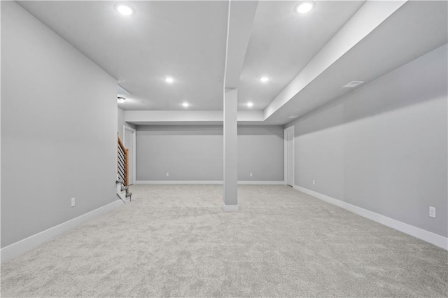 basement featuring light carpet