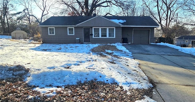 single story home featuring a garage and a storage unit