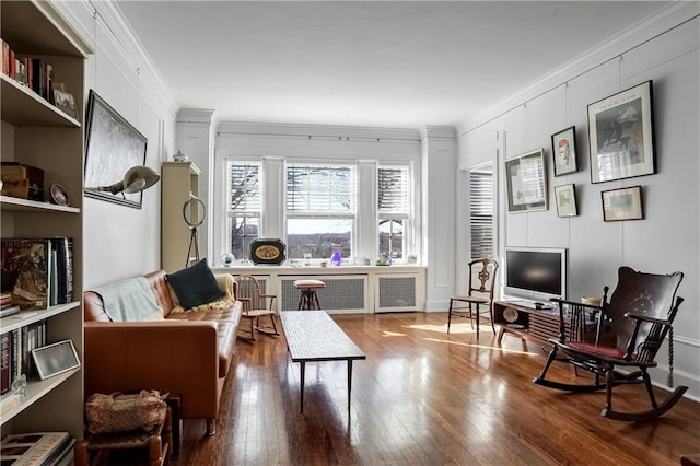 living area featuring crown molding and wood-type flooring