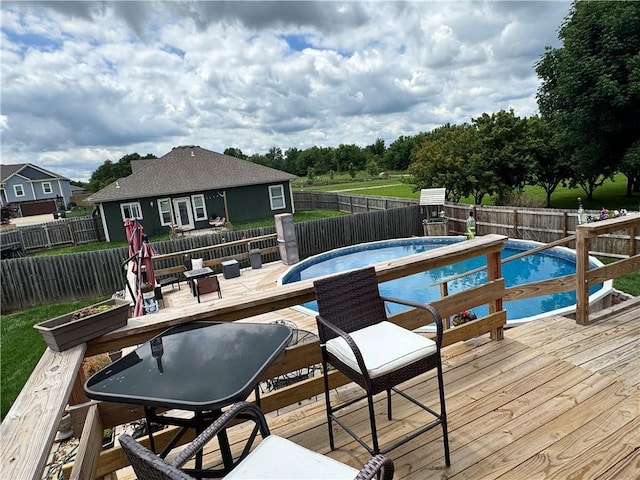 304 S Jackson St, Archie, MO 64725 - view of swimming pool with a wooden deck and a fenced backyard