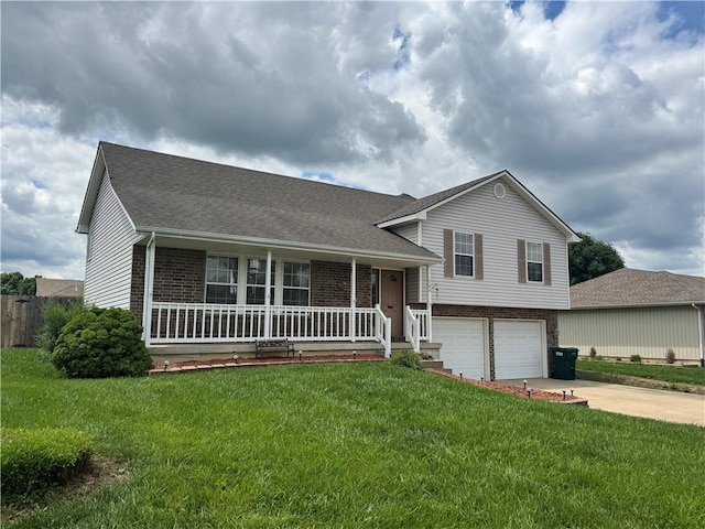 304 S Jackson St, Archie, MO 64725 - split level home featuring brick siding, covered porch, an attached garage, concrete driveway, and roof with shingles