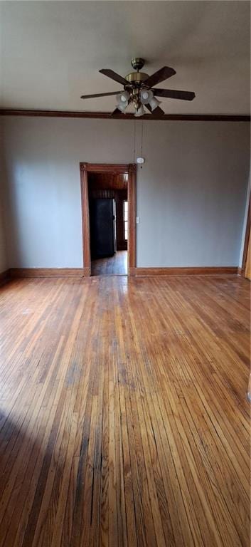 unfurnished living room with ceiling fan, hardwood / wood-style floors, and crown molding