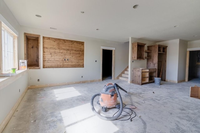 interior space featuring stairway and baseboards