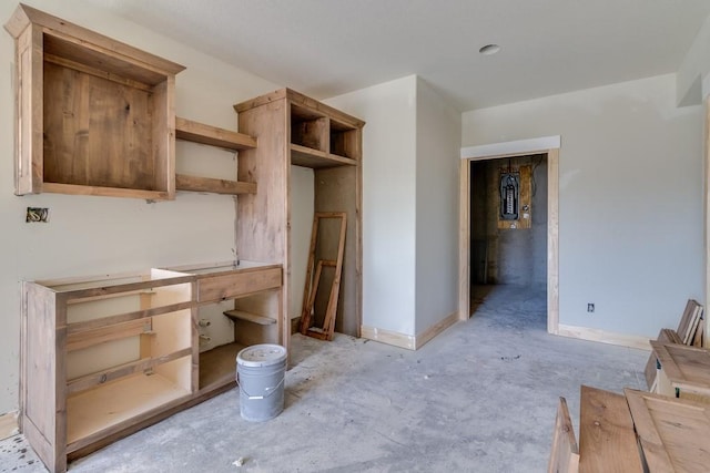 kitchen featuring concrete flooring and open shelves