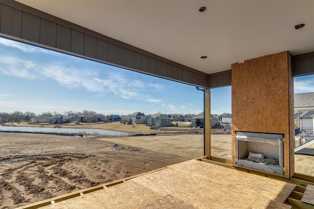 view of yard with a residential view, a patio area, and a water view