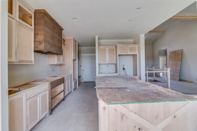 kitchen with a kitchen island and light stone countertops