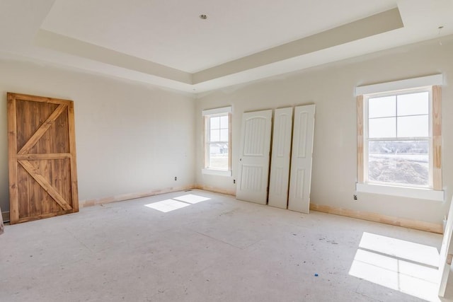 unfurnished bedroom with a tray ceiling