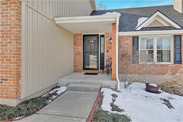 view of snow covered property entrance