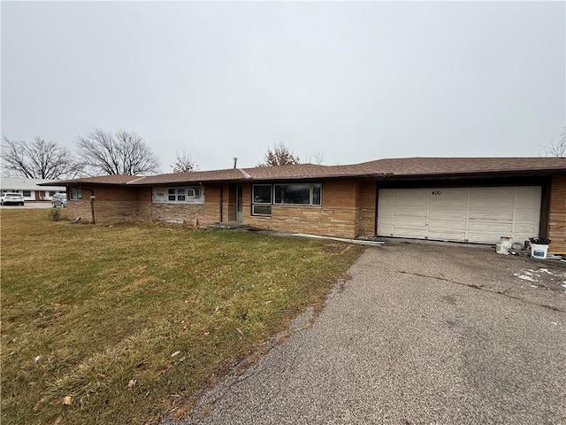 single story home featuring a garage and a front yard