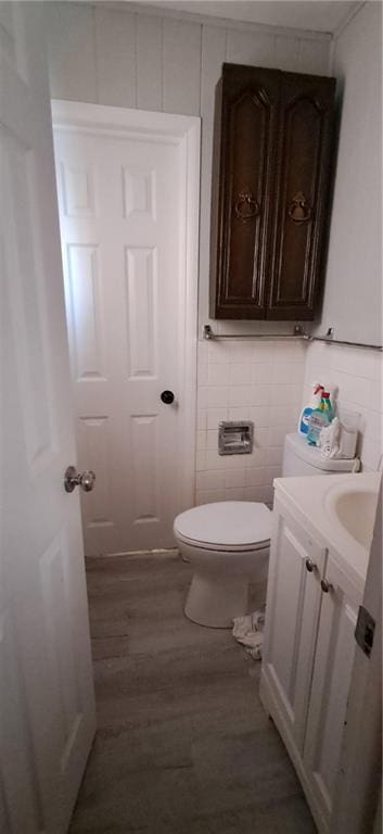 bathroom featuring vanity, toilet, and wood-type flooring