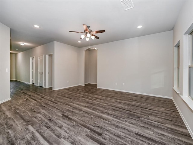 spare room featuring dark wood-type flooring and ceiling fan